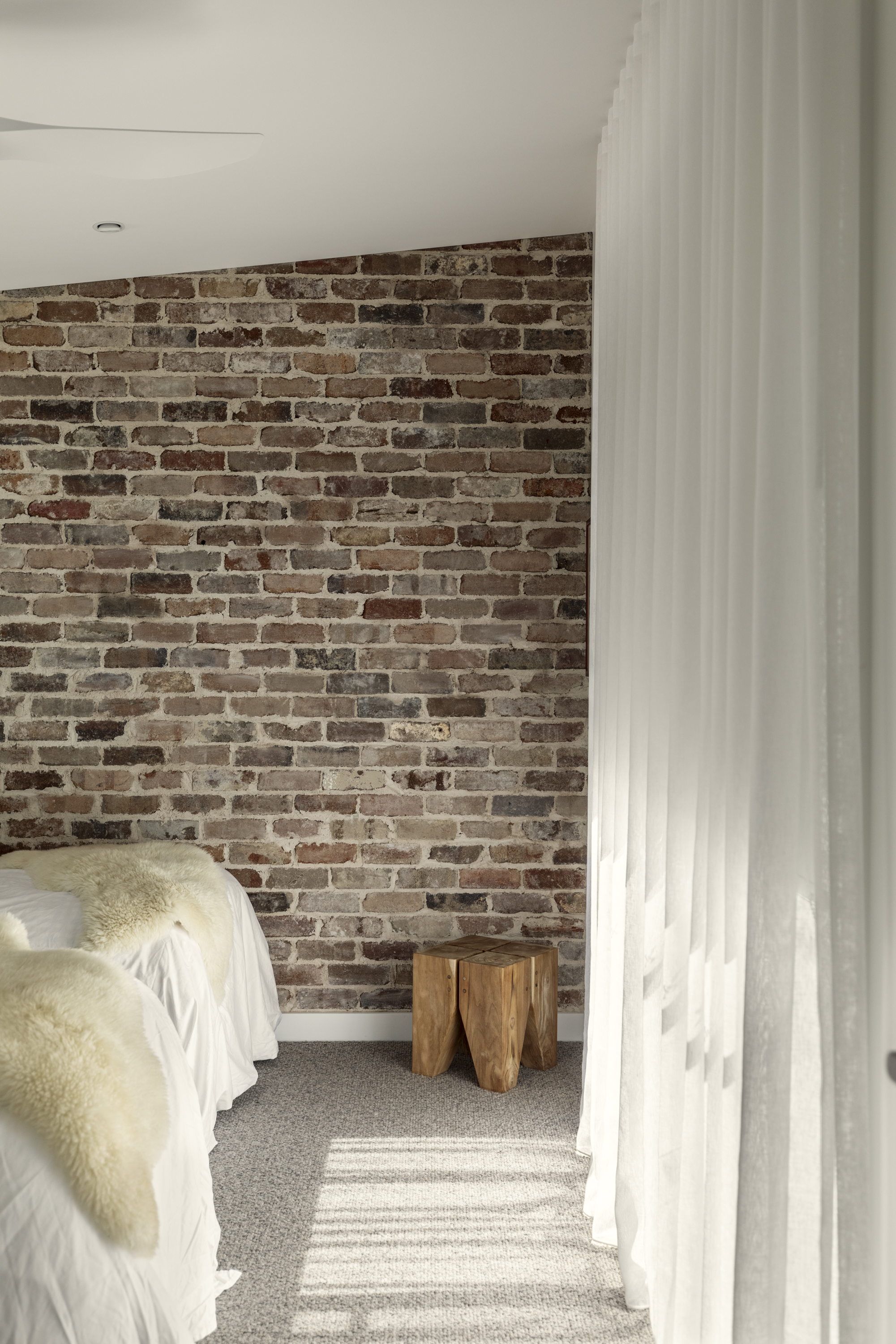 Living room with exposed brick feature wall and polished concrete
