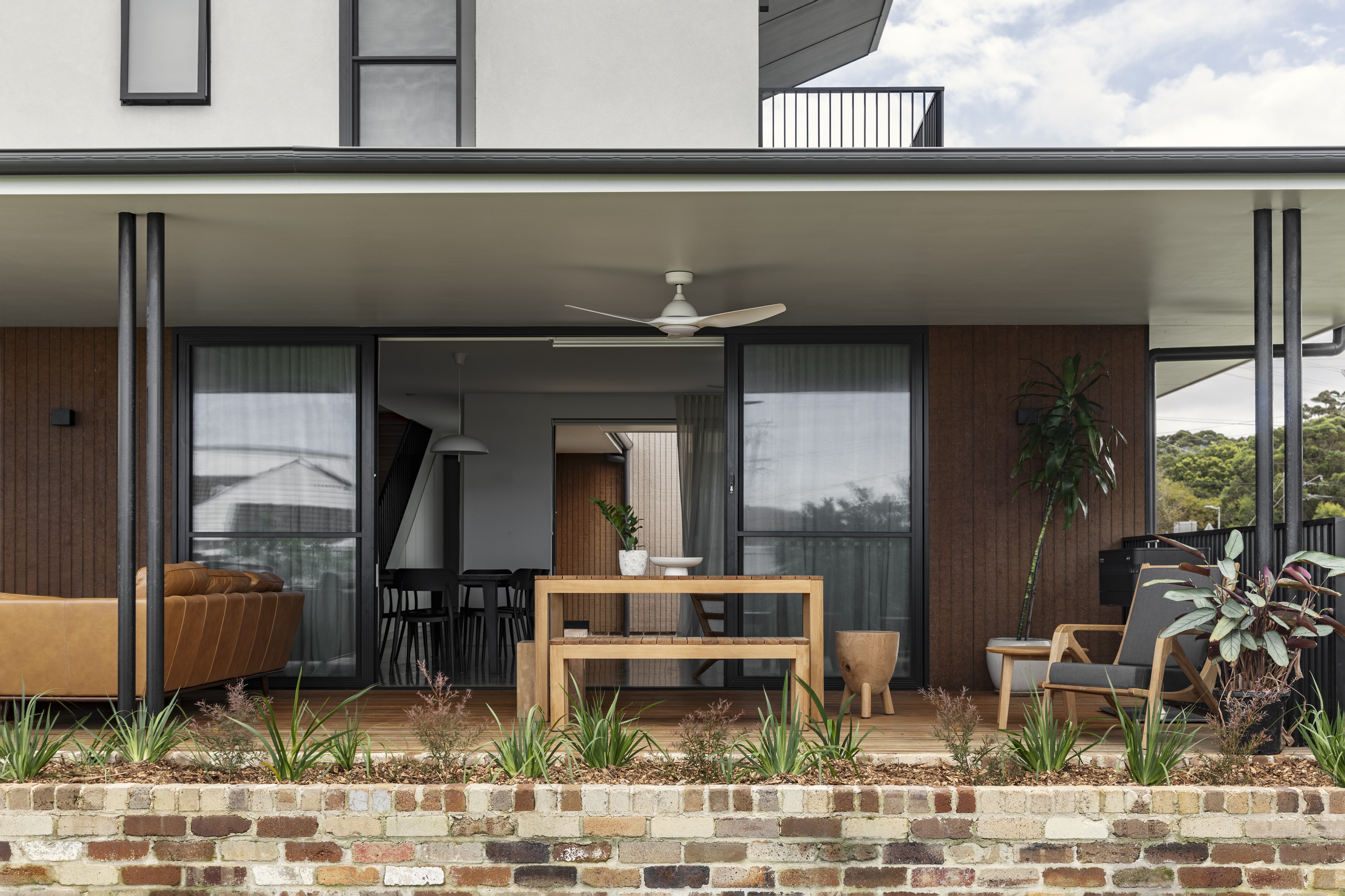 Brick courtyard with cushions and landscaping